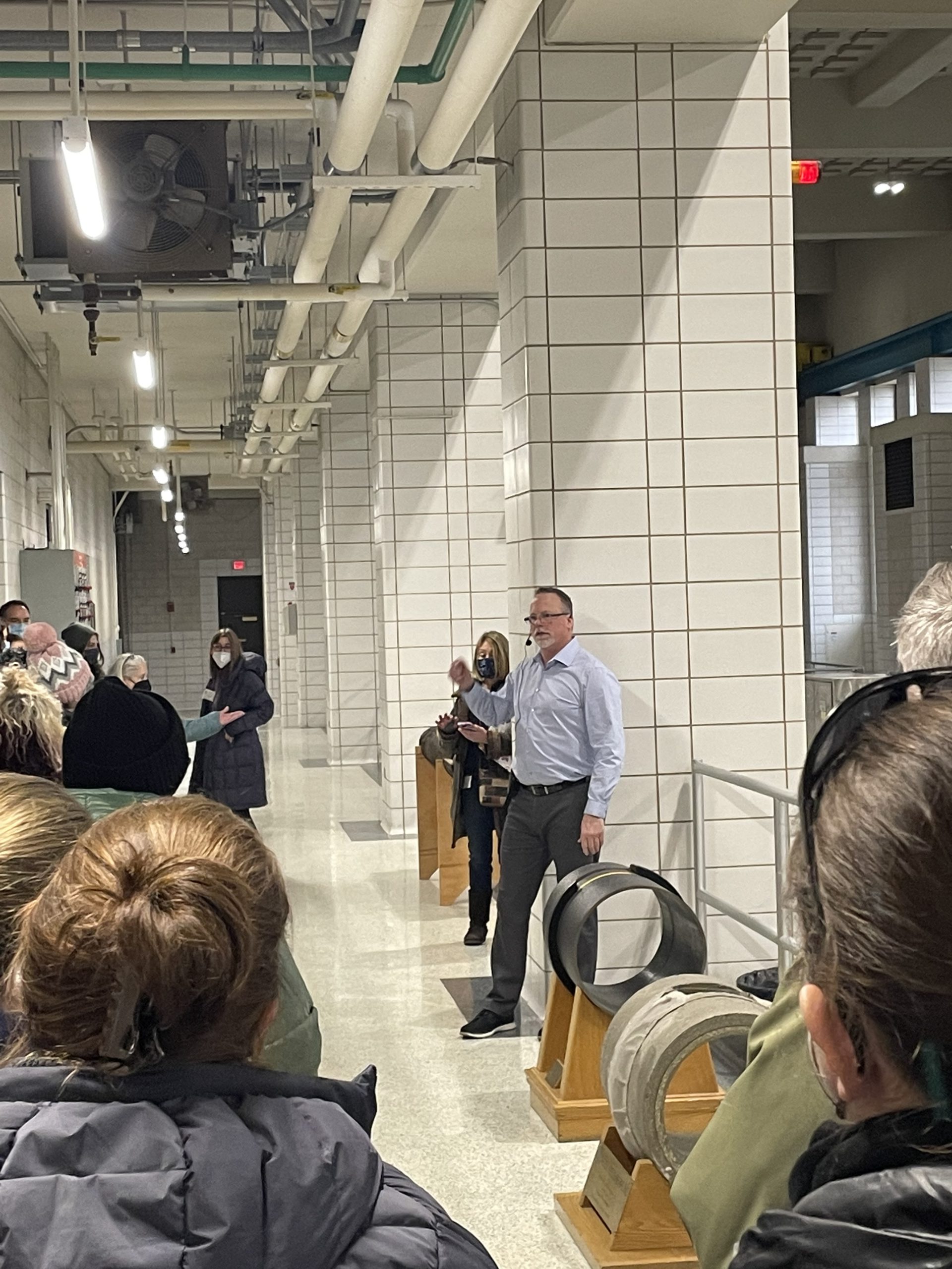 people in a pump room listening to a presenter